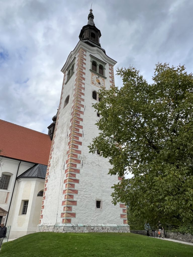 The free-standing bell tower of The Pilgrimage Church of the Assumption of Mary on an island in Lake Bled, Slovenia.