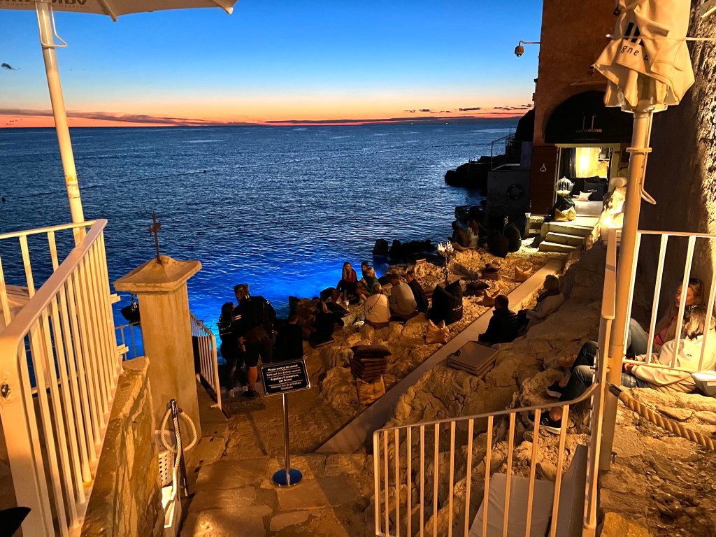 La Puntulina in one of Rovinj's most popular restaurants where diners sip cocktails and dine on rocky outcrops at the water’s edge