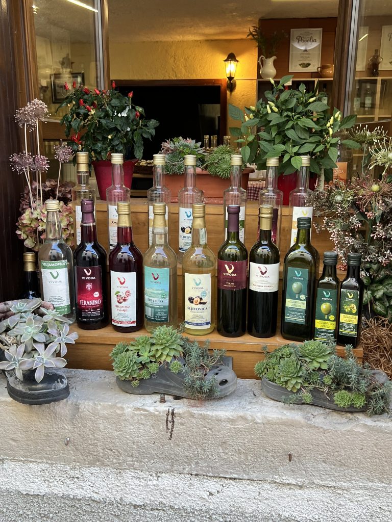 Liquors, olive oil and clogs on the window sill of a tavern or konoba in Motovun, Croatia.